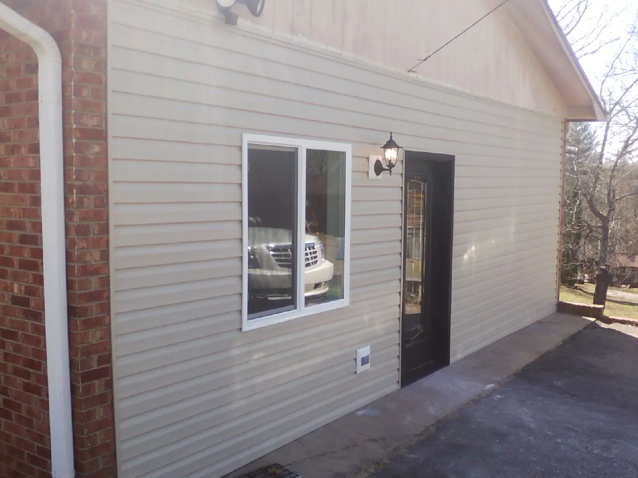 New vinyl siding and entry door on a room addition in Blowing Rock